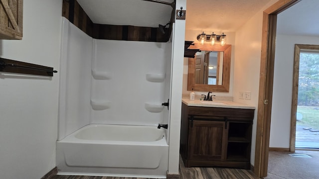 full bath with shower / bathtub combination, baseboards, and vanity