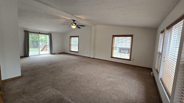 carpeted spare room featuring ceiling fan, baseboards, vaulted ceiling with beams, and a textured ceiling