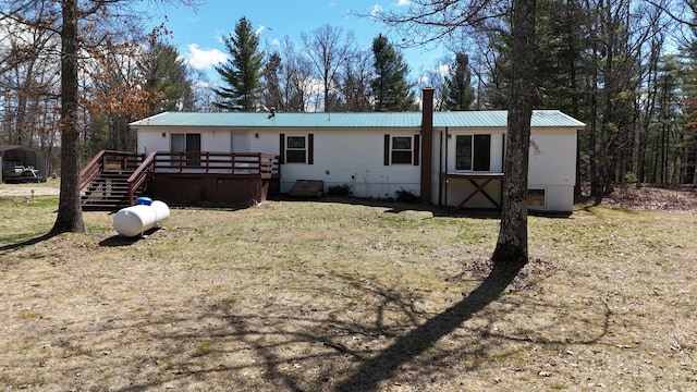 view of front of property featuring a wooden deck and metal roof
