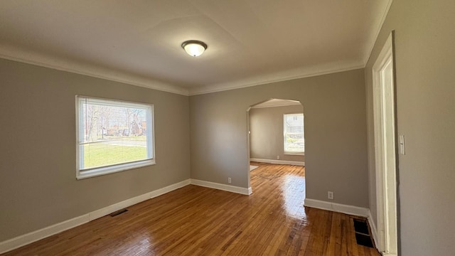 5051 Courville St, Detroit, MI 48224 - empty room with arched walkways, ornamental molding, and plenty of natural light