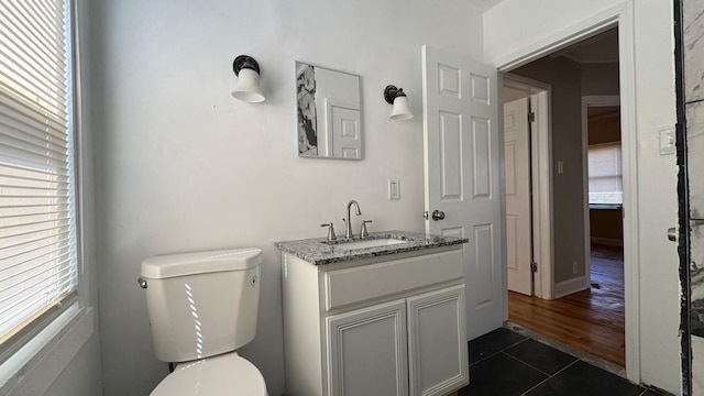 5051 Courville St, Detroit, MI 48224 - half bath featuring toilet, vanity, tile patterned floors, and plenty of natural light