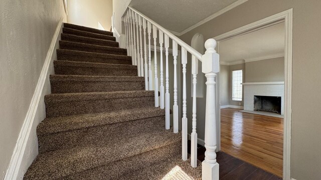 5051 Courville St, Detroit, MI 48224 - staircase featuring baseboards, crown molding, a brick fireplace, and wood finished floors