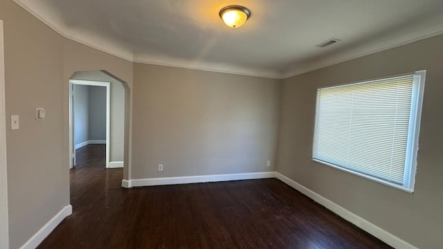 5051 Courville St, Detroit, MI 48224 - empty room with arched walkways, baseboards, visible vents, and dark wood-type flooring