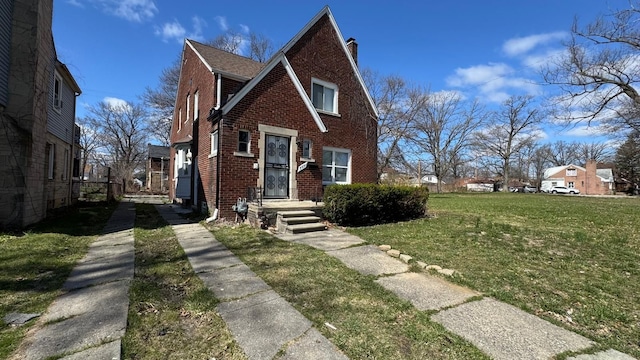 5051 Courville St, Detroit, MI 48224 - english style home with brick siding, a chimney, and a front yard