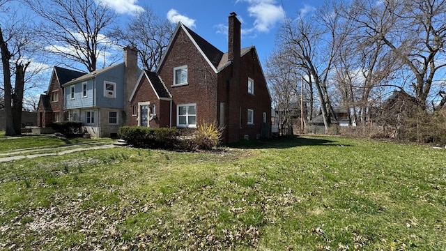 5051 Courville St, Detroit, MI 48224 - view of property exterior featuring a lawn, a chimney, and brick siding