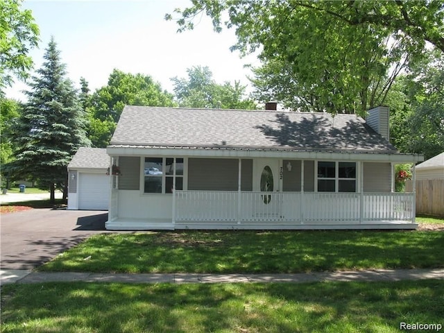 702 Oda St, Davison, MI 48423 - view of front of property with a porch, a chimney, a front lawn, and asphalt driveway
