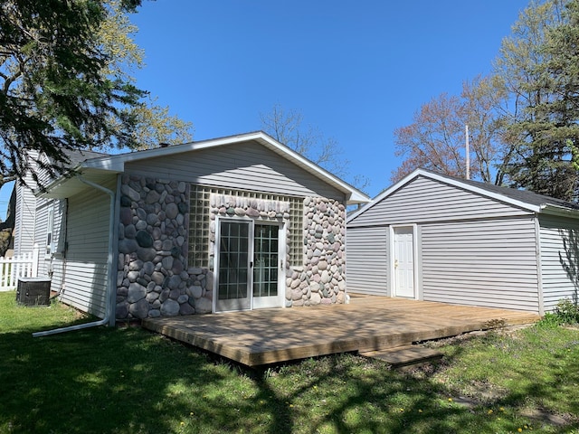 702 Oda St, Davison, MI 48423 - rear view of property featuring a deck, a lawn, central AC, and stone siding