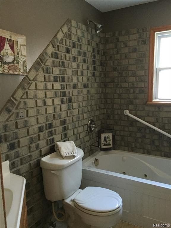 702 Oda St, Davison, MI 48423 - bathroom with toilet, a combined bath / shower with jetted tub, and tile walls