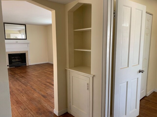 702 Oda St, Davison, MI 48423 - hall with wood finished floors, baseboards, and built in shelves