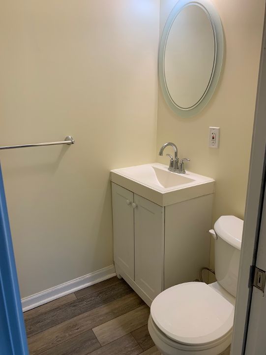 702 Oda St, Davison, MI 48423 - bathroom with vanity, toilet, and wood finished floors