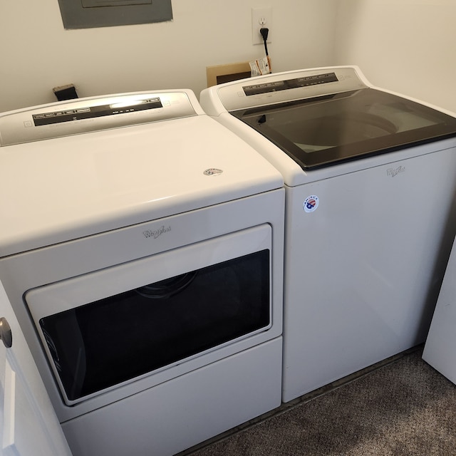 laundry room with washing machine and clothes dryer, carpet, and electric panel