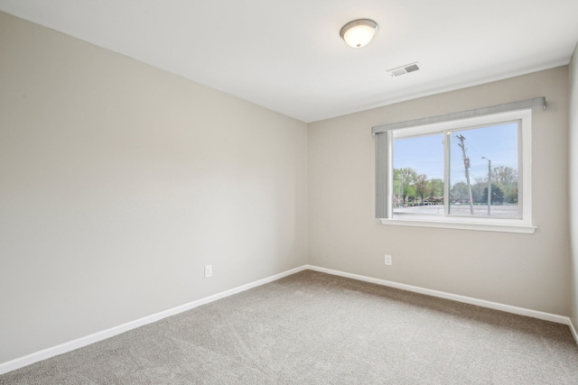 unfurnished room with baseboards and carpet flooring