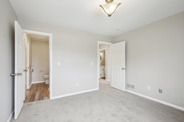 unfurnished bedroom with carpet flooring and baseboards