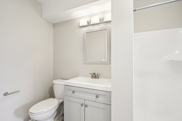 bathroom featuring toilet and vanity