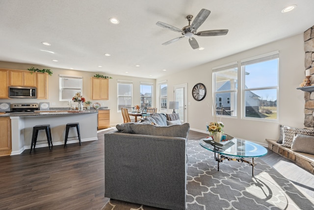 living room with dark wood-type flooring, baseboards, ceiling fan, and recessed lighting