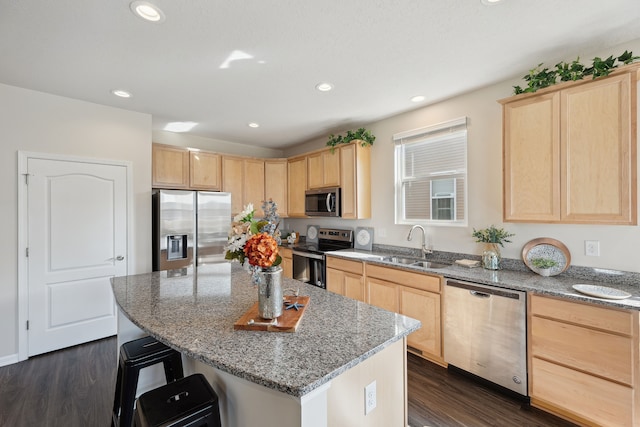 kitchen with stainless steel appliances, light brown cabinets, a sink, and dark wood-style flooring