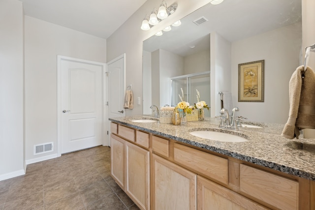 full bathroom with visible vents, a stall shower, and a sink