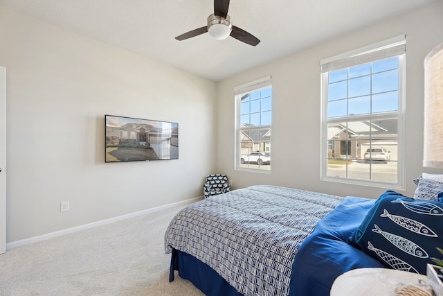 bedroom featuring carpet floors, a ceiling fan, and baseboards