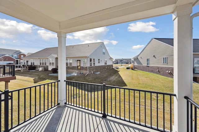 wooden deck featuring a yard and a residential view