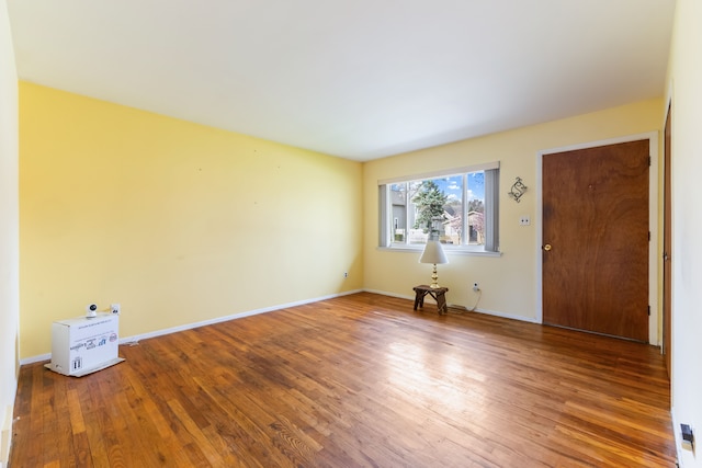 interior space featuring wood finished floors and baseboards