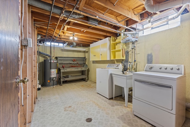 washroom with gas water heater, separate washer and dryer, cabinet space, and a wealth of natural light