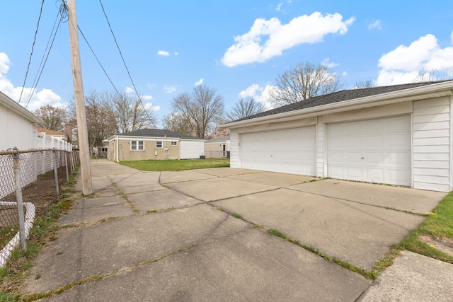 detached garage featuring fence