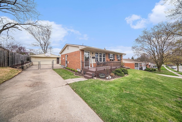 view of front of house with a gate, fence, a front lawn, brick siding, and a garage