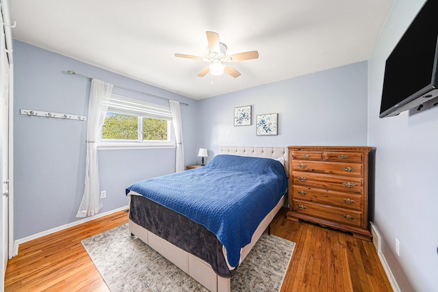 bedroom featuring baseboards, a ceiling fan, and wood finished floors