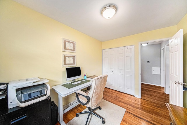 office space featuring baseboards and light wood-style floors