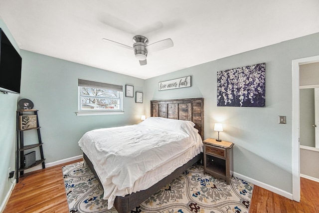 bedroom featuring baseboards, a ceiling fan, and wood finished floors