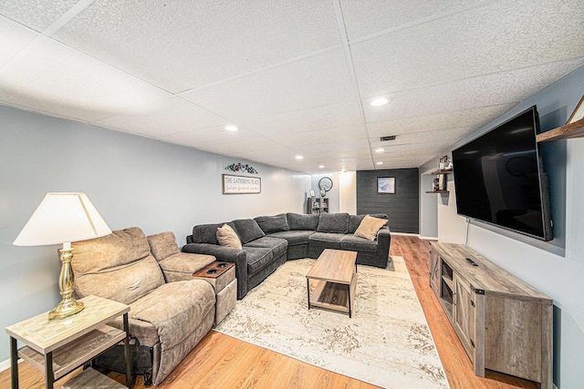 living area featuring recessed lighting, wood finished floors, visible vents, and a drop ceiling