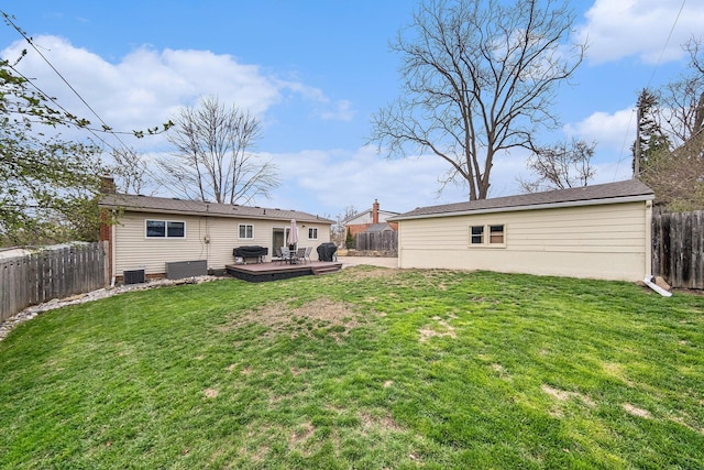 back of house with a wooden deck, a yard, central AC, and a fenced backyard