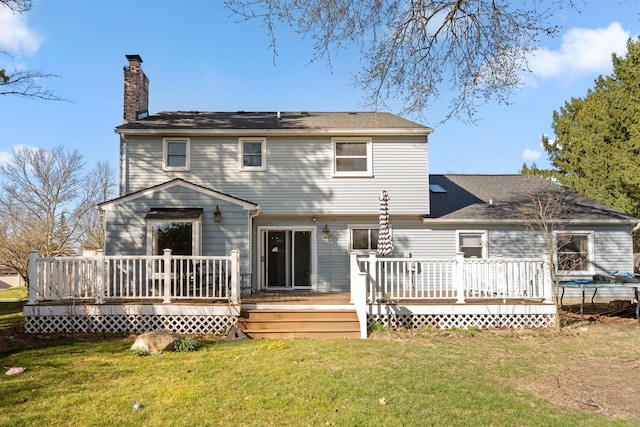 back of house featuring a wooden deck, a lawn, and a chimney