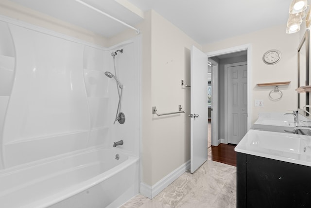 full bathroom featuring a sink, double vanity, shower / bathtub combination, baseboards, and marble finish floor