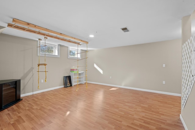 basement featuring recessed lighting, baseboards, visible vents, and light wood-type flooring