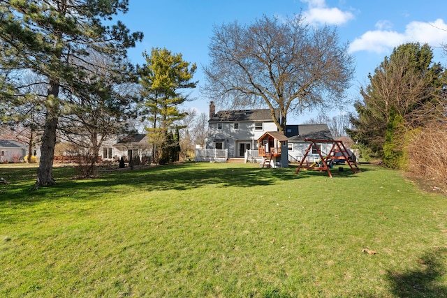 view of yard featuring a playground and a deck