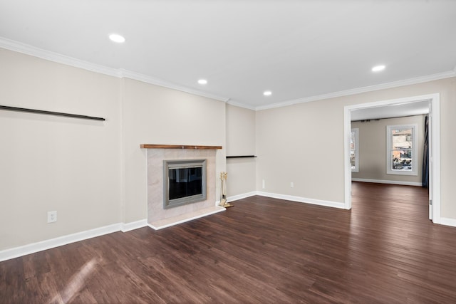 unfurnished living room with crown molding, a premium fireplace, baseboards, dark wood-type flooring, and recessed lighting