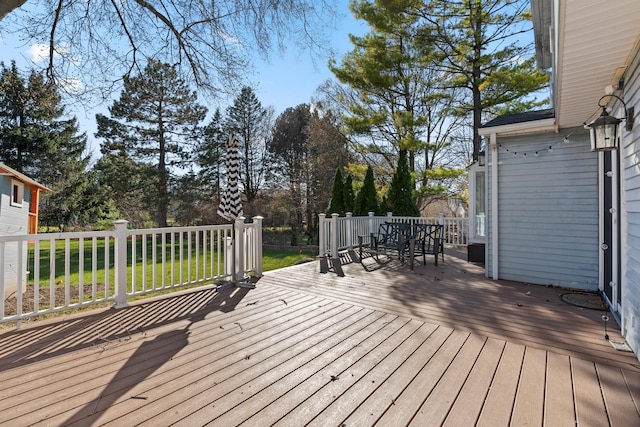 wooden terrace featuring outdoor dining area