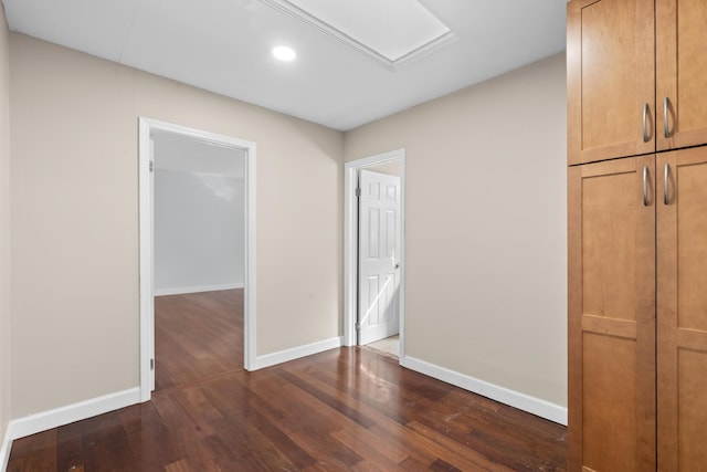 interior space with baseboards, dark wood-style flooring, and recessed lighting