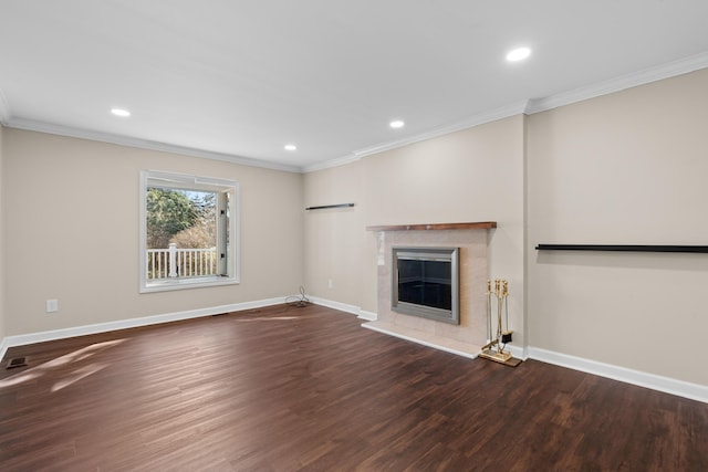 unfurnished living room featuring baseboards, ornamental molding, wood finished floors, and a premium fireplace