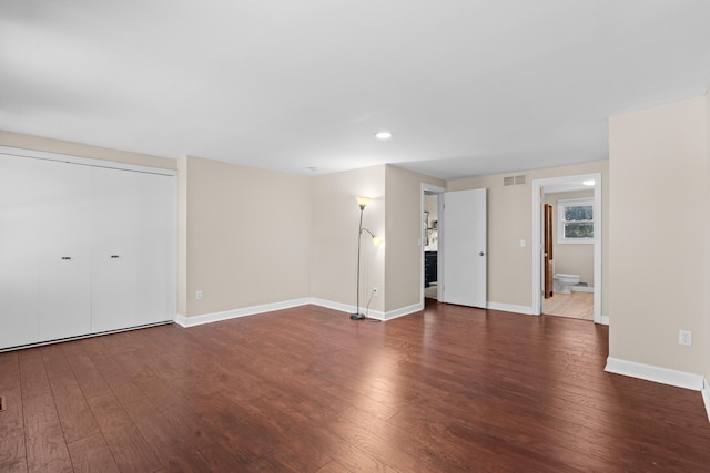 unfurnished living room featuring baseboards, hardwood / wood-style floors, visible vents, and recessed lighting