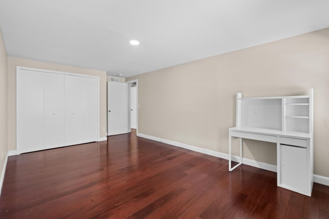 unfurnished bedroom featuring recessed lighting, wood finished floors, visible vents, a closet, and baseboards