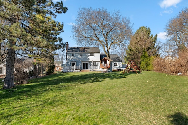 view of yard with a wooden deck and a playground