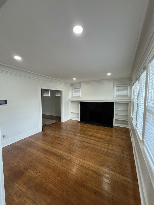 unfurnished living room with recessed lighting, crown molding, baseboards, and dark wood-style flooring