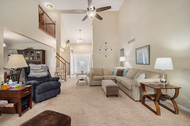 living room featuring stairs, high vaulted ceiling, visible vents, and carpet