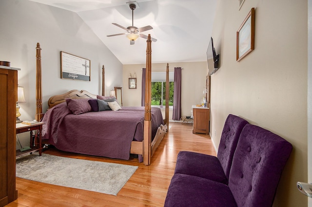 bedroom with a ceiling fan, lofted ceiling, and light wood finished floors