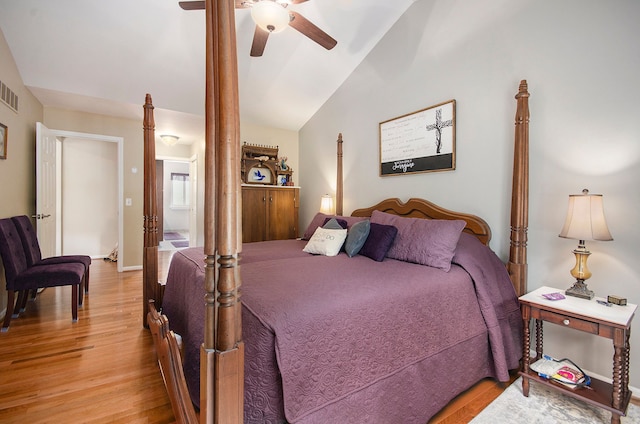 bedroom featuring visible vents, a ceiling fan, lofted ceiling, and wood finished floors