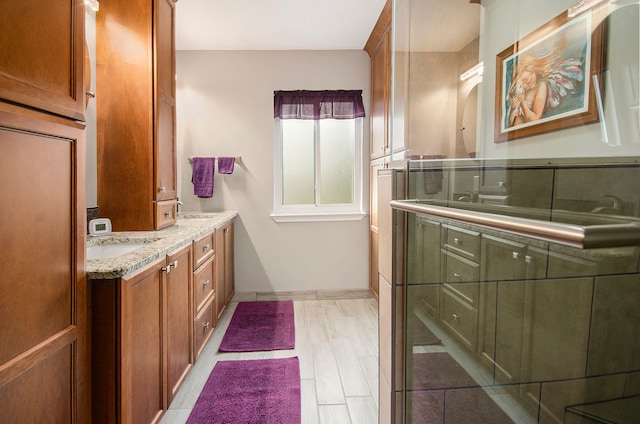 bathroom with a sink, baseboards, and double vanity