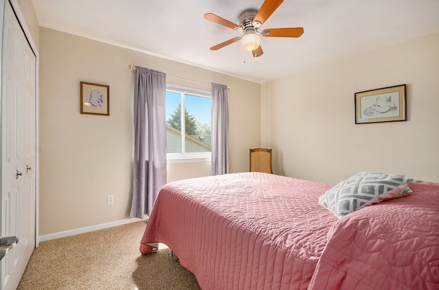 carpeted bedroom with a closet, a ceiling fan, and baseboards