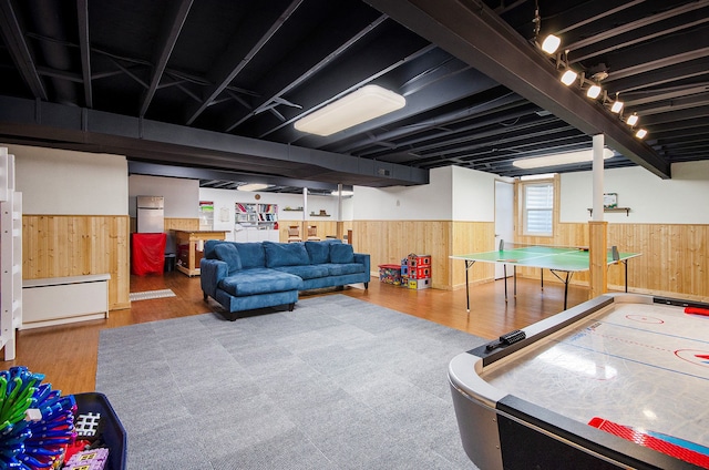 recreation room with wainscoting and wooden walls
